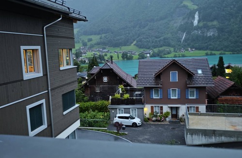 Lungern Condo | “Wake Up to Lake & Mountain Views with a Magical Summer Waterfall”
